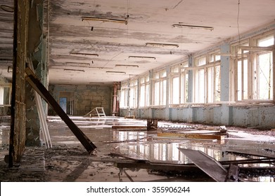 big abandoned hall with big broken windows, white  on the floor and puddles. - Powered by Shutterstock