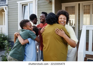 Big African American Family Embracing Outdoors Welcoming Guests For Party