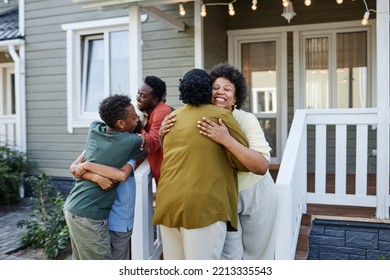 Big African American family embracing outdoors welcoming guests for housewarming party - Powered by Shutterstock