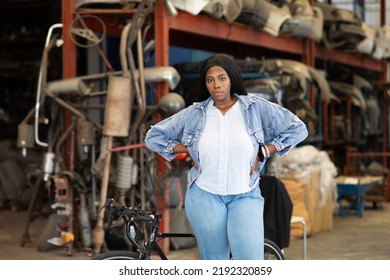 Big African American Woman Modeling. Old Machine Auto Parts In Warehouses. Auto Mechanic Car Service, Repair And Maintenance Concept. Used Car-auto Mobile Spare Parts