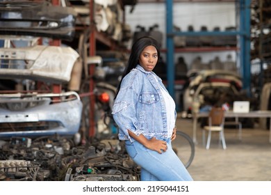 Big African American Woman Modeling. Old Machine Auto Parts In Warehouses. Auto Mechanic Car Service, Repair And Maintenance Concept. Used Car-auto Mobile Spare Parts