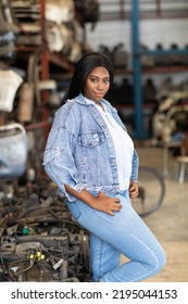 Big African American Woman Modeling. Old Machine Auto Parts In Warehouses. Auto Mechanic Car Service, Repair And Maintenance Concept. Used Car-auto Mobile Spare Parts