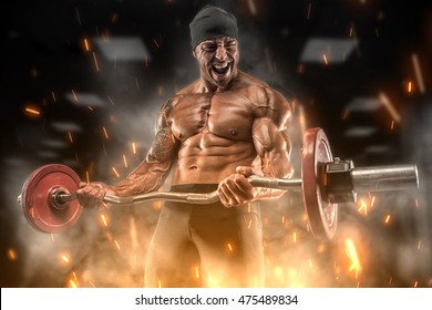 Big angry athlete trains in the gym