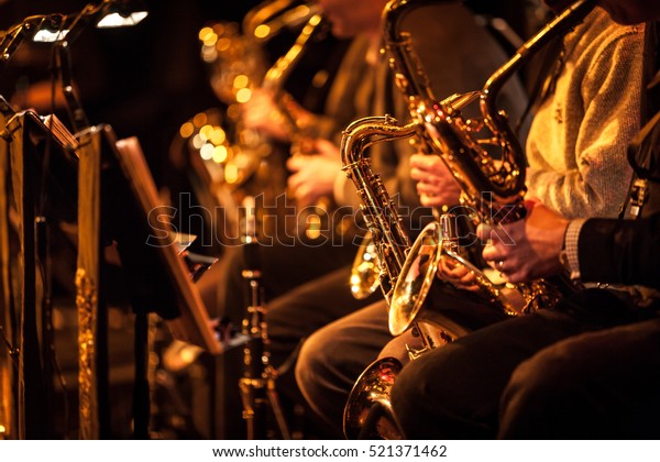 Big Band saxophone section. A\
candid view along the saxophone section of a big band in\
concert.\
