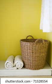 big basket and towels in yellow background. - Shutterstock ID 71528554