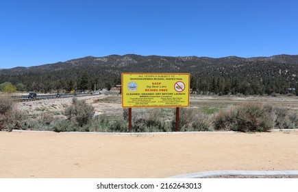 Big Bear Lake, CA USA - May 21, 2022: The Quagga Or Zebra Mussel Inspection Sign With View Of The Dry Stanfield Marsh Wildlife And Waterfowl Preserve Due To Severe Drought.