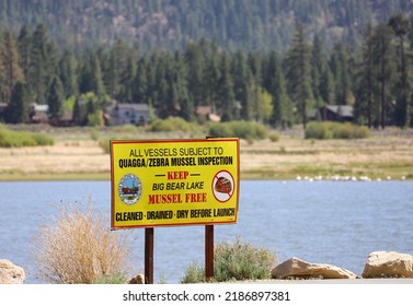 Big Bear Lake, CA USA - May 21, 2022: The Quagga Or Zebra Mussel Inspection Sign With View Of The Big Bear Lake On The Background.