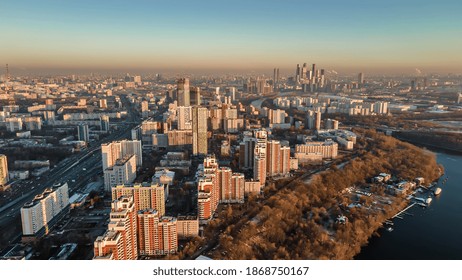 A big and beautiful city from a bird's eye view. City in the rays of the sun at sunset. Park, river, many houses and roads. Beautiful Moscow. - Powered by Shutterstock