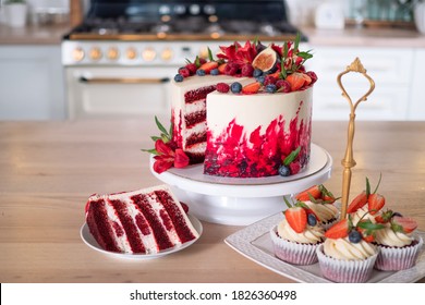 Big beautiful red velvet cake, with flowers and berries on top. Slice on a plate, dessert. Cake and muffins, sweet holiday treats.