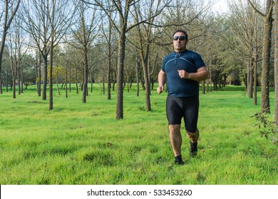 Big Belly Man Jogging - Exercising, Doing Cardio In The Park - Slightly Overweight  Loosing Weight - Young Overweight Man Running Outdoors - Fat Man Running