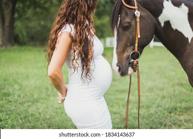 Big belly pregnant woman with horse