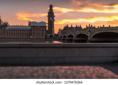Big Ben Clock Tower Under Maintenance And Houses Of Parliament At City Of Westminster Viewed From Across The River Thames
