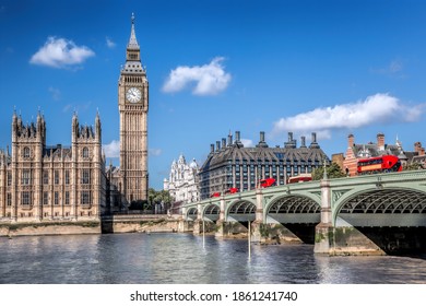 Big Ben and Houses of Parliament with red buses on the bridge in London, England, UK - Shutterstock ID 1861241740