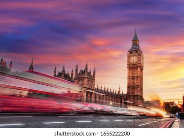 Big Ben with red bus against colorful sunset in London, England, UK