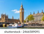 Big Ben tower of Houses of Parliament and Westminster pier, London, UK