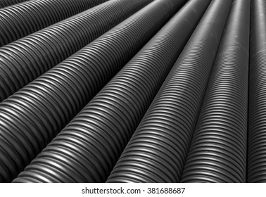 Big Black Plastic Pipes Lie Side By Side