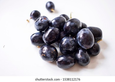 Big Black Spanish Grapes Over A White Background