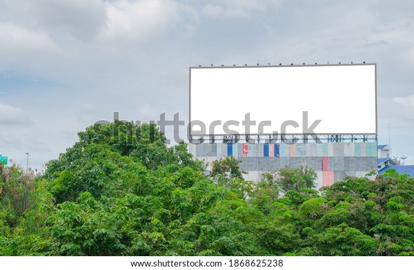 big blank billboard fabric white\
screen side road on building in city side road. blank ad mockup\
copy space for advertising banner near bus stop in\
metropolis.