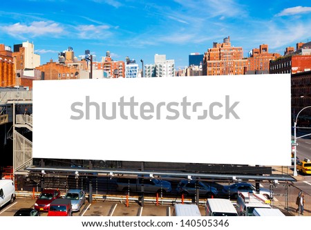 Big blank billboard in New York City, surrounded by highrise buildings and a bright blue sky overhead