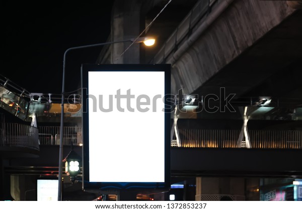 big blank\
billboard white LED screen vertical outstanding in the city on\
pathway side the road traffic with car for display advertisement\
text template promotion new brand at\
outdoor.