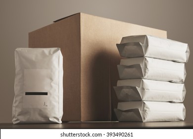 Big blank bulky sealed package with product presented in front of carton craft box and column of other packages. Ready for shipping, delivery and sale. Small business artisan concept. - Powered by Shutterstock