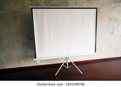 Big Blank Portable Tripod Projection Screen In Yoga Hall Beautiful Background Wall. Side Angle