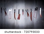 Big bloody knife and kitchen items hanging on the wall in blood.Halloween.