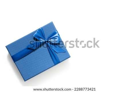 big blue gift box with a blue bow on a white background banner, free space, top view, mockup for design