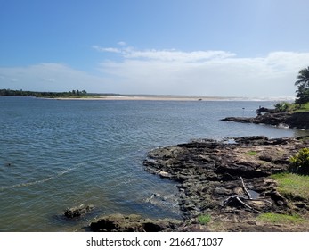 Big Blue River With Tree-lined Beach On The Horizon