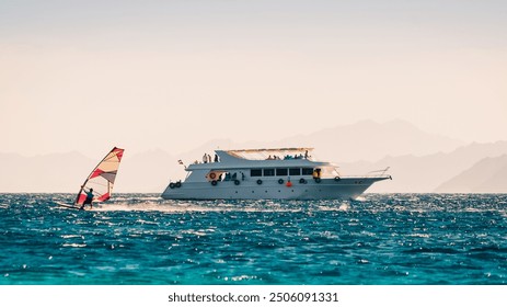 big boat and a surfer in the sea on the background of a rocky coast in Egypt Dahab - Powered by Shutterstock