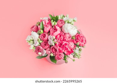 big bouquet of peonies in a box on a pink background top view copy space. Greeting card with March 8 or mother's day - Powered by Shutterstock