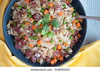 Big Bowl Of Homemade Vietnamese Fried Rice And Chinese Sausage With Yellow Napkin And Serving Spoon