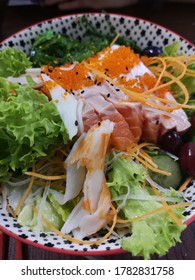 A Big Bowl Salad With Ample Of Salmon Slices, Crab Meat And Fish Roes.