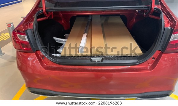 Big box of standard\
dining table and other home shopping stuff fit into the car boot or\
rear cargo of a car.