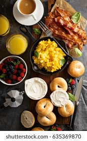 Big Breakfast With Bacon, Bagels And Scrambled Eggs On The Table Overhead