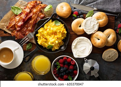 Big Breakfast With Bacon, Bagels And Scrambled Eggs On The Table Overhead