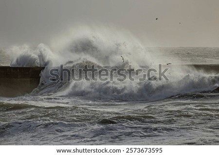 Big breaking waves over river mouth pier, north of Portugal.