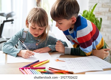 Big Brother Helping His Sister With Her Homework                               