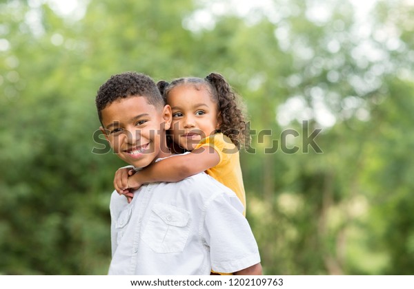 Big Brother Holding His Little Sister Stock Photo (Edit Now) 1202109763