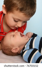 Big Brother Looking At His Baby Brother Yawning