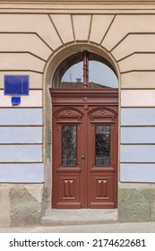 Big Brown Double Door With Transom Window In Arch House