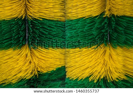 Big brushes of automatic machine Car Wash. Caring for a vehicle. Colored dynamic background