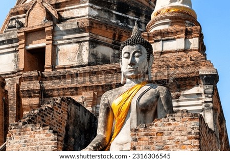 Big Buddha statue in front of temple Wat Yai Chai Mongkol (or Mongkhon) in Ayutthaya Historical Park, Thailand. Wat Yai Chai Mongkol  is buddhist temple complex in Ayutthaya near Bangkok, Thailand.