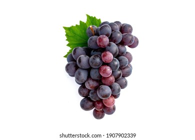 Big bunch of fruit red grapes with green grape leaves on white background