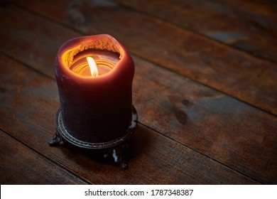 Big candle on wooden table. Burning candle in a candlestick, vintage gothic style, copy space. Design for magic ritual and predictions - Shutterstock ID 1787348387