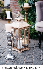 Big Candles Next To Elegant Sofa Set Up In Beige Pastels For A Wedding Ceremony