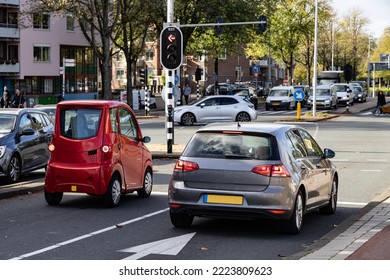 Big Car And Small Car At Traffic Lights Amsterdam