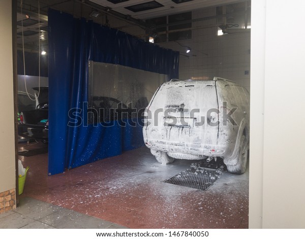 big car in white foam\
in a car wash box