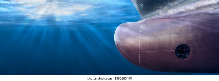 Big Cargo Ship Sailing In The Sea To Shipping Container Terminal. Close Up Image Detail Ships Bow, Underwater View. Shipping Business And Underwater Survey Concept. Hull Maintenance And Inspection.