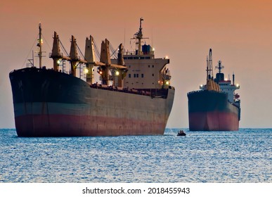 Big Cargo Ships Near The African Shores During Dust Storm